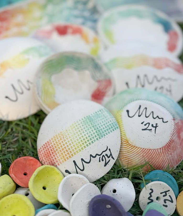 Colorful ceramic pieces resting in grass
